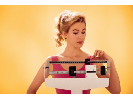 Woman-weighing-herself-on-scale.jpg